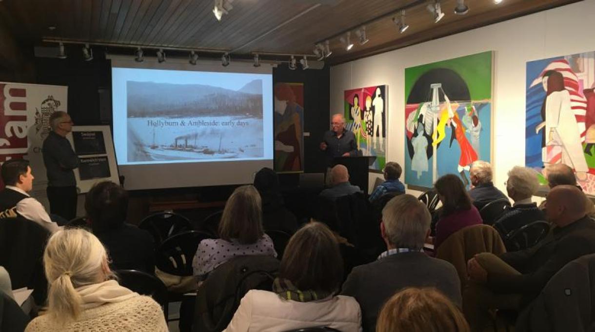 Man presenting a talk to a seated audience